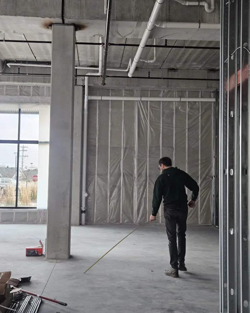Measuring out the empty shop space during build-out